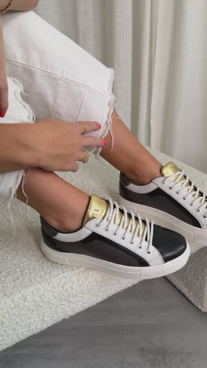 white sneakers with gold zipper